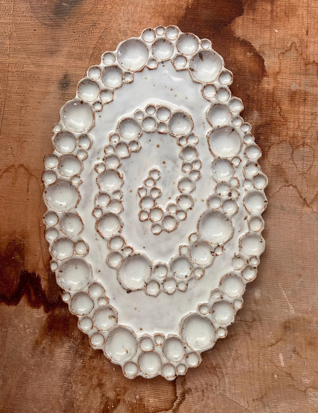 Ceramic spiral bubble palette against wood background 