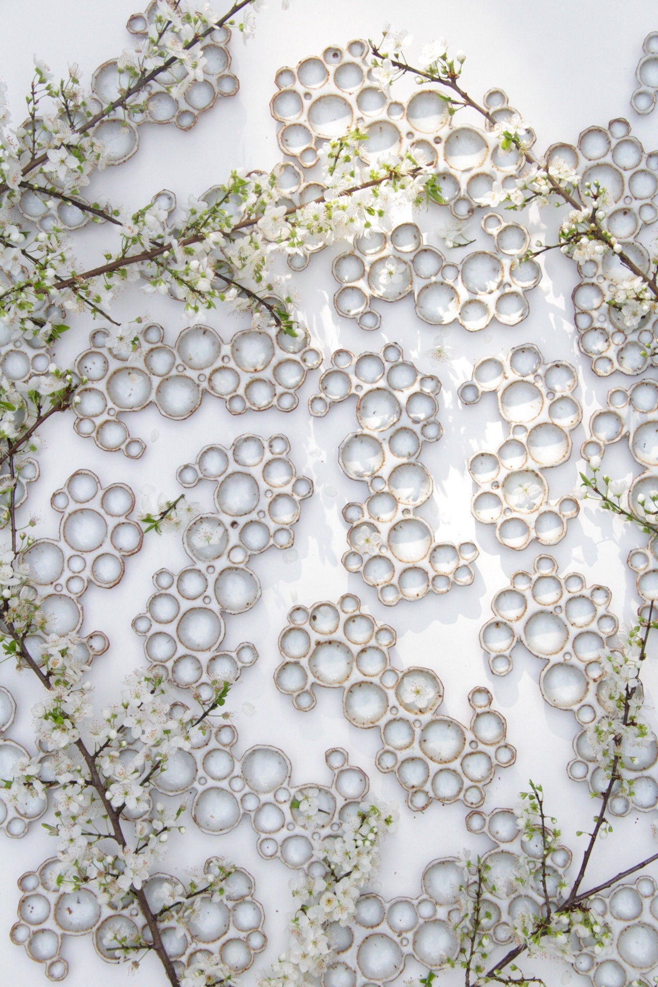 multiple ceramic bubble palettes arranged together against white background with flowers 