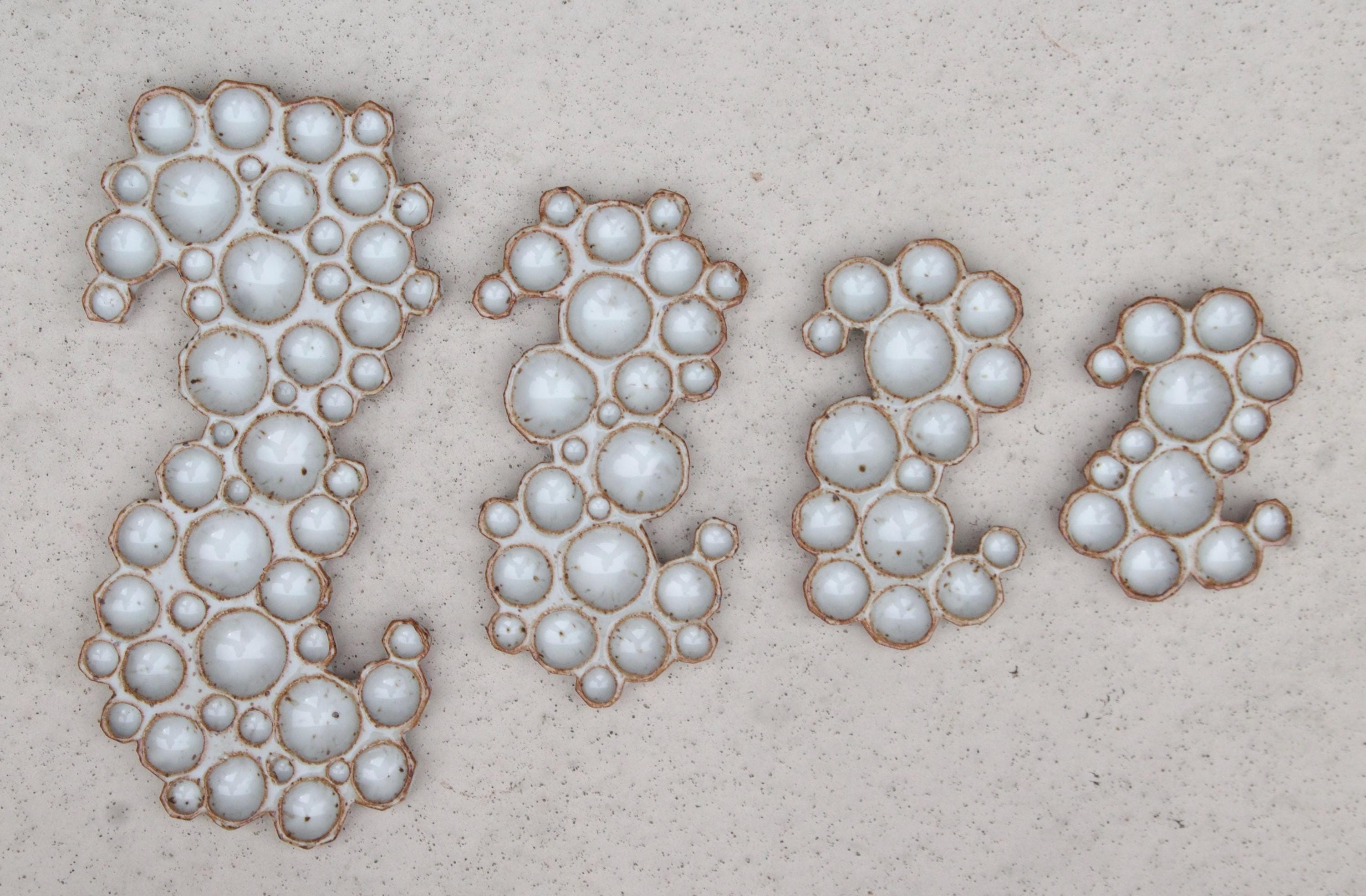 X-large, large, medium and small ceramic bubble palettes lined up next to each other on white background 