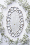Large ceramic oval bubble palette against white background with flowers 
