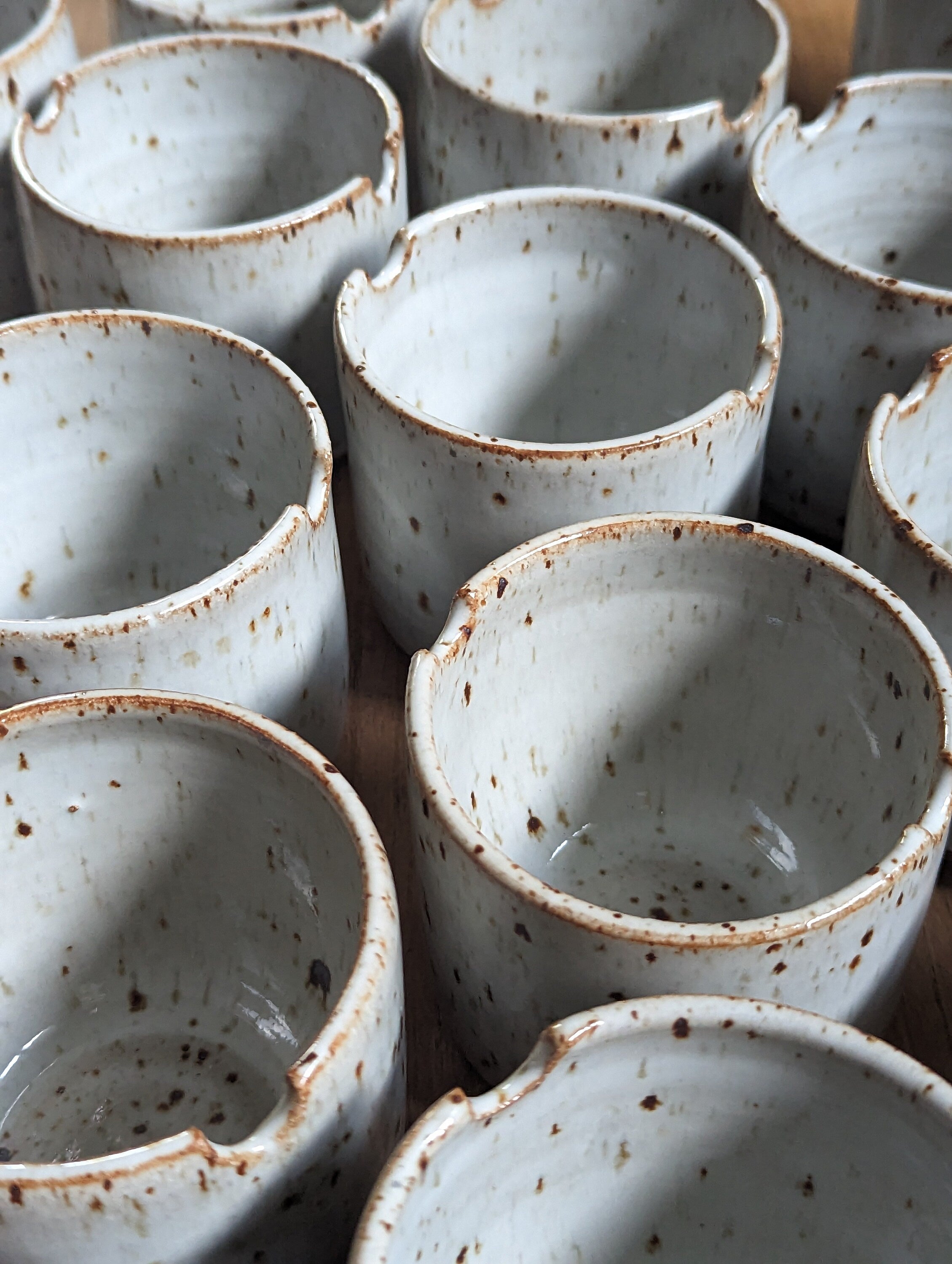 multiple ceramic watercolor cups arranged together 