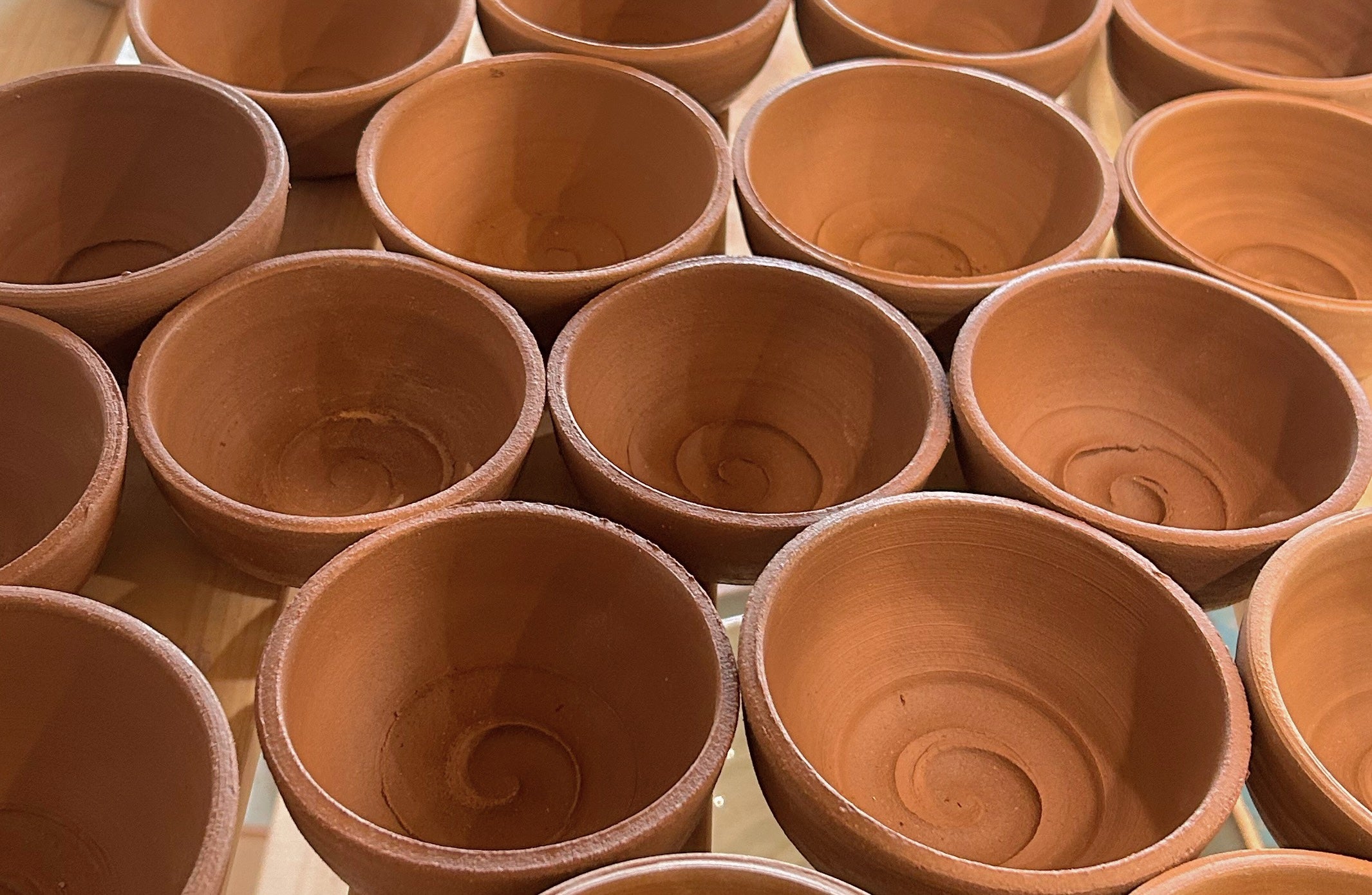 Many small ceramic bowls arranged together 