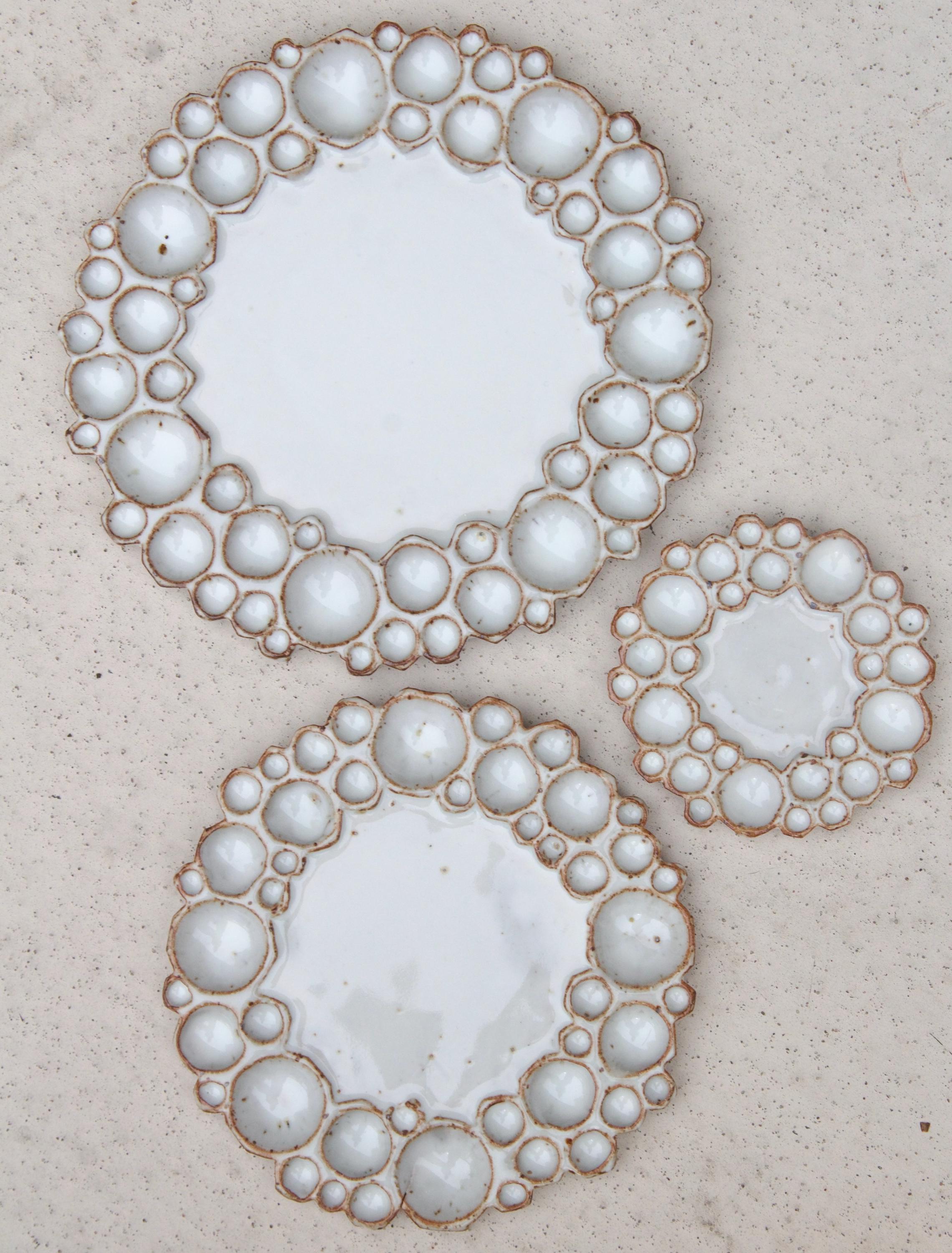 Three different sized round bubble palettes beside each other against beige background 
